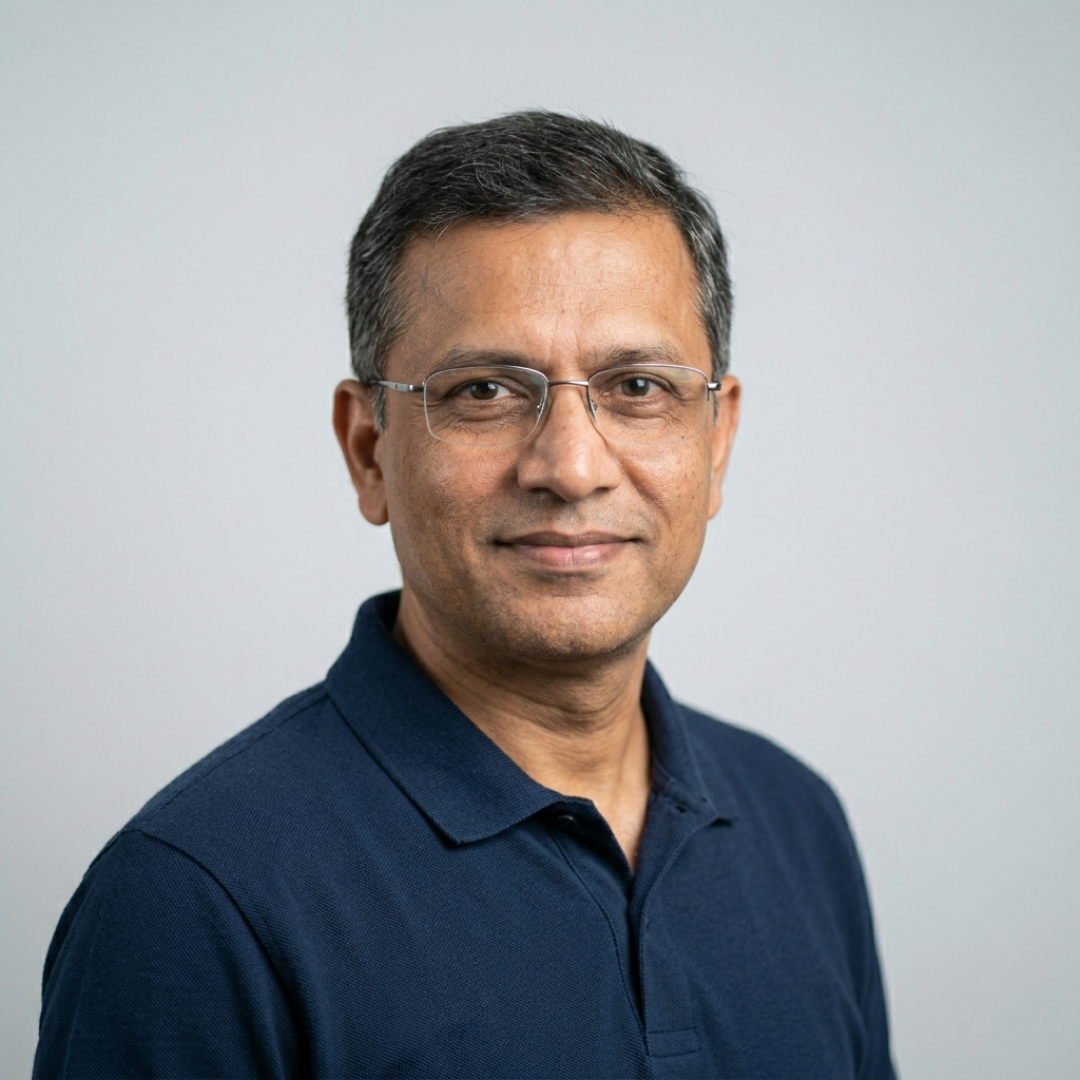 Experienced male research analyst in a professional headshot with a confident expression